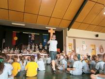 Students seated in a school hall watching a presenter at the front during an assembly